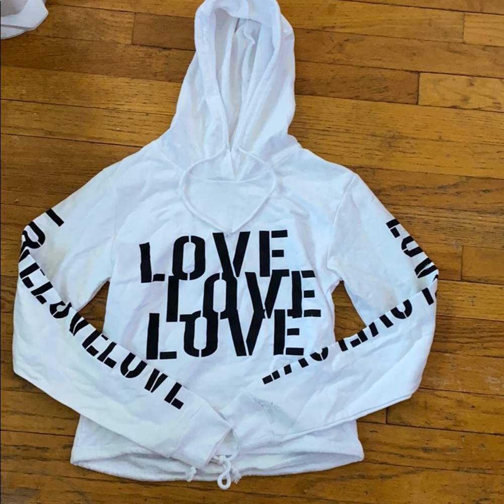 A white hoodie with love written on it
